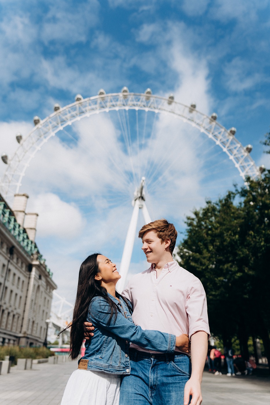 Couple laughing together in front of the London Eye