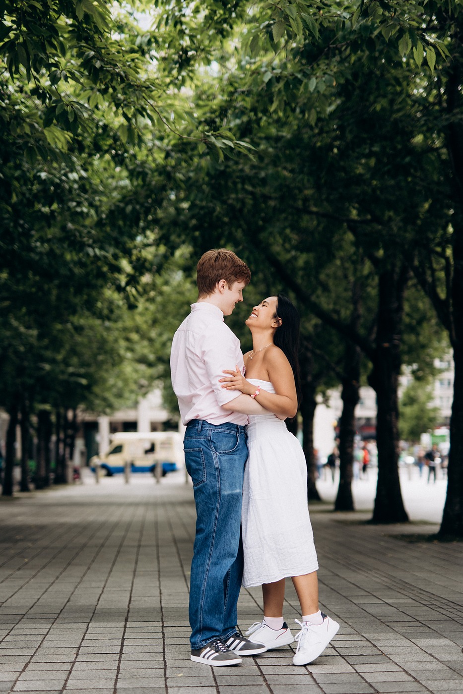 Man twirling his partner under the plane trees along the Embankment