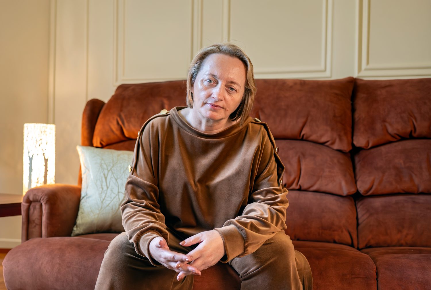 Relaxed personal brand portrait on a velvet sofa