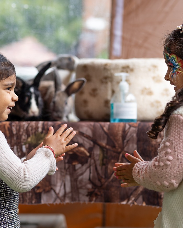 Children meeting a rabbit at a birthday party