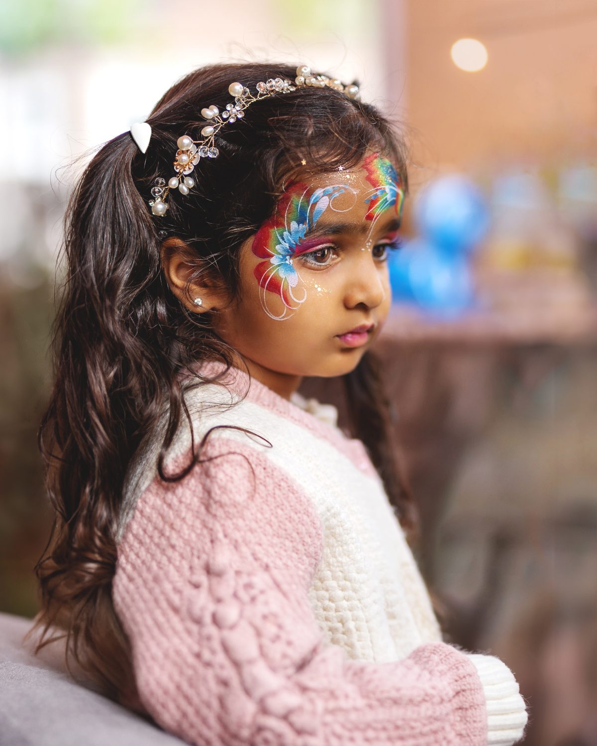 Girl with face paint at a birthday party in Surrey
