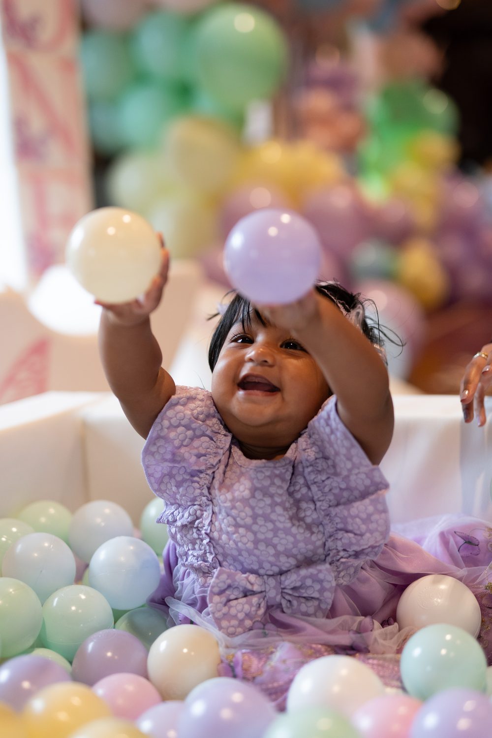 Baby playing in a ball pit at a family session in Surrey