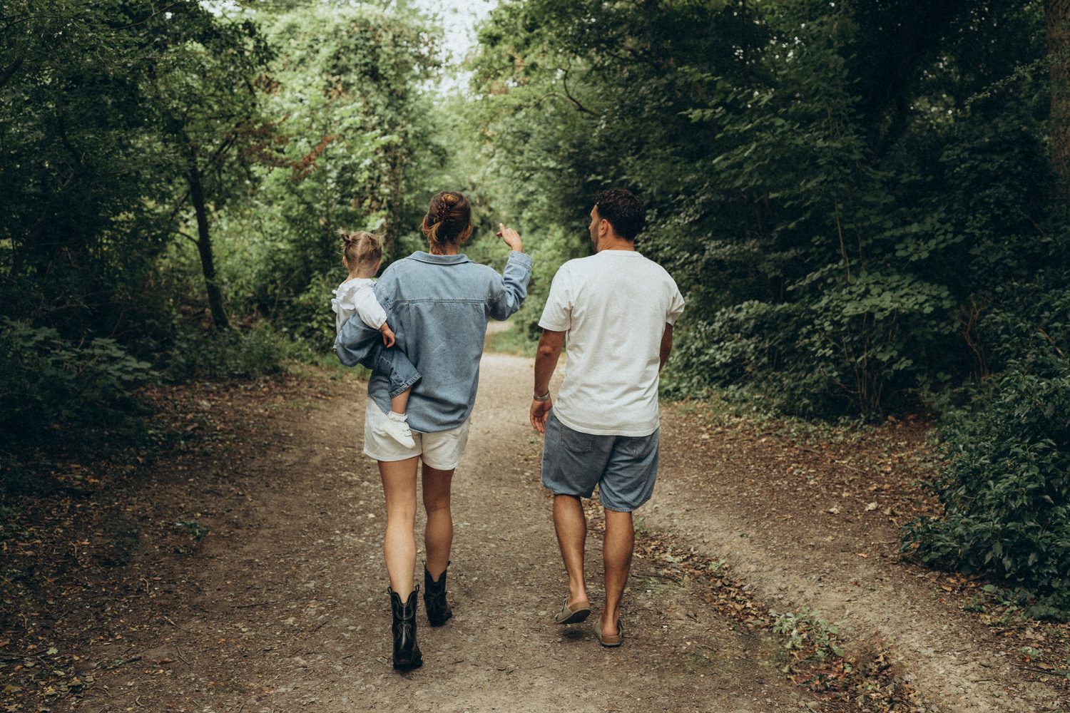 Family walking a wooded Surrey path, mum in a denim shirt and boots