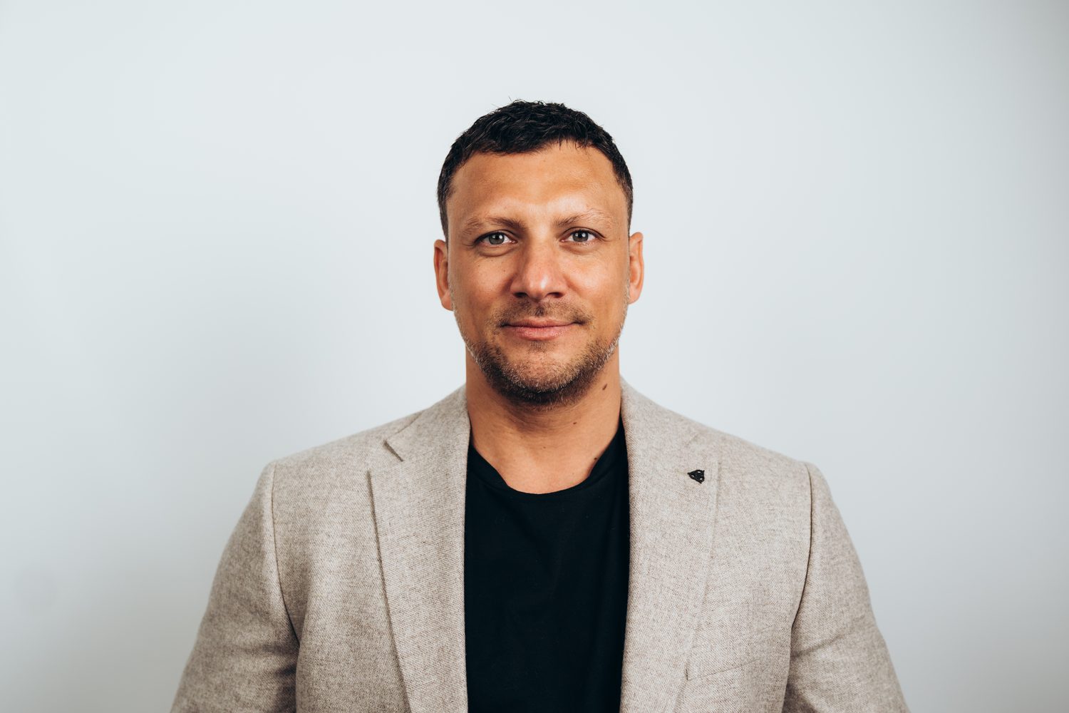 Business headshot of a man in a blazer on a white background, Surrey
