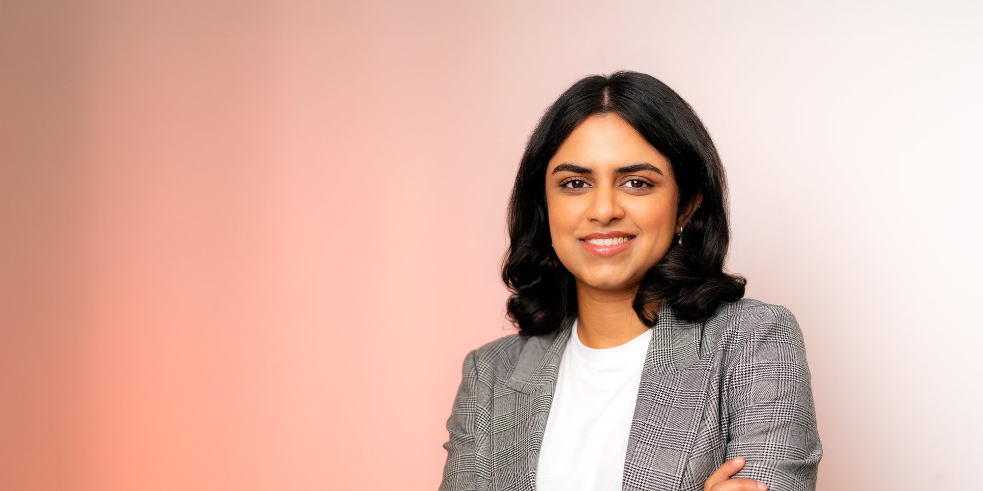 Natural professional headshot of a woman in a checked blazer, Surrey