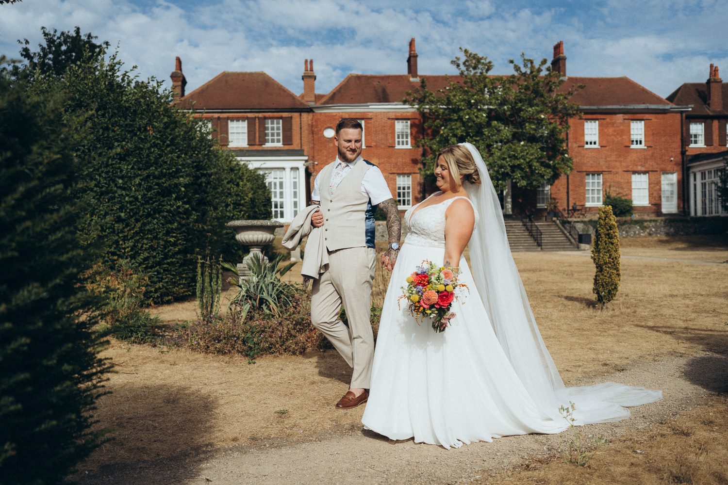 Bride and groom in the grounds of Leatherhead Register Office, Surrey