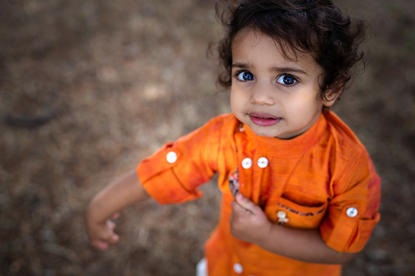 Toddler looking up at the camera on a family shoot in Surrey