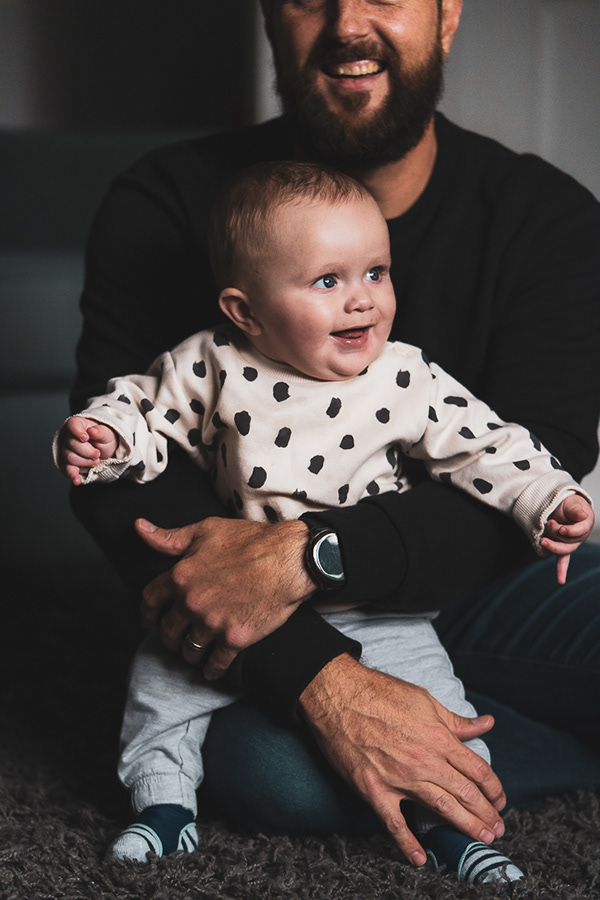 Father holding his baby daughter at home in Surrey