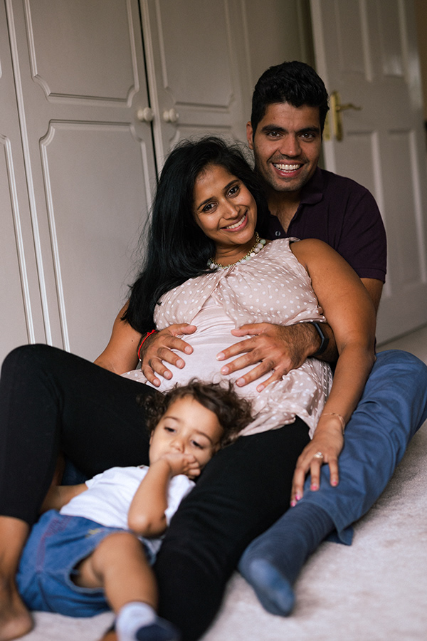 Expecting parents with their toddler during a maternity session at home in Surrey