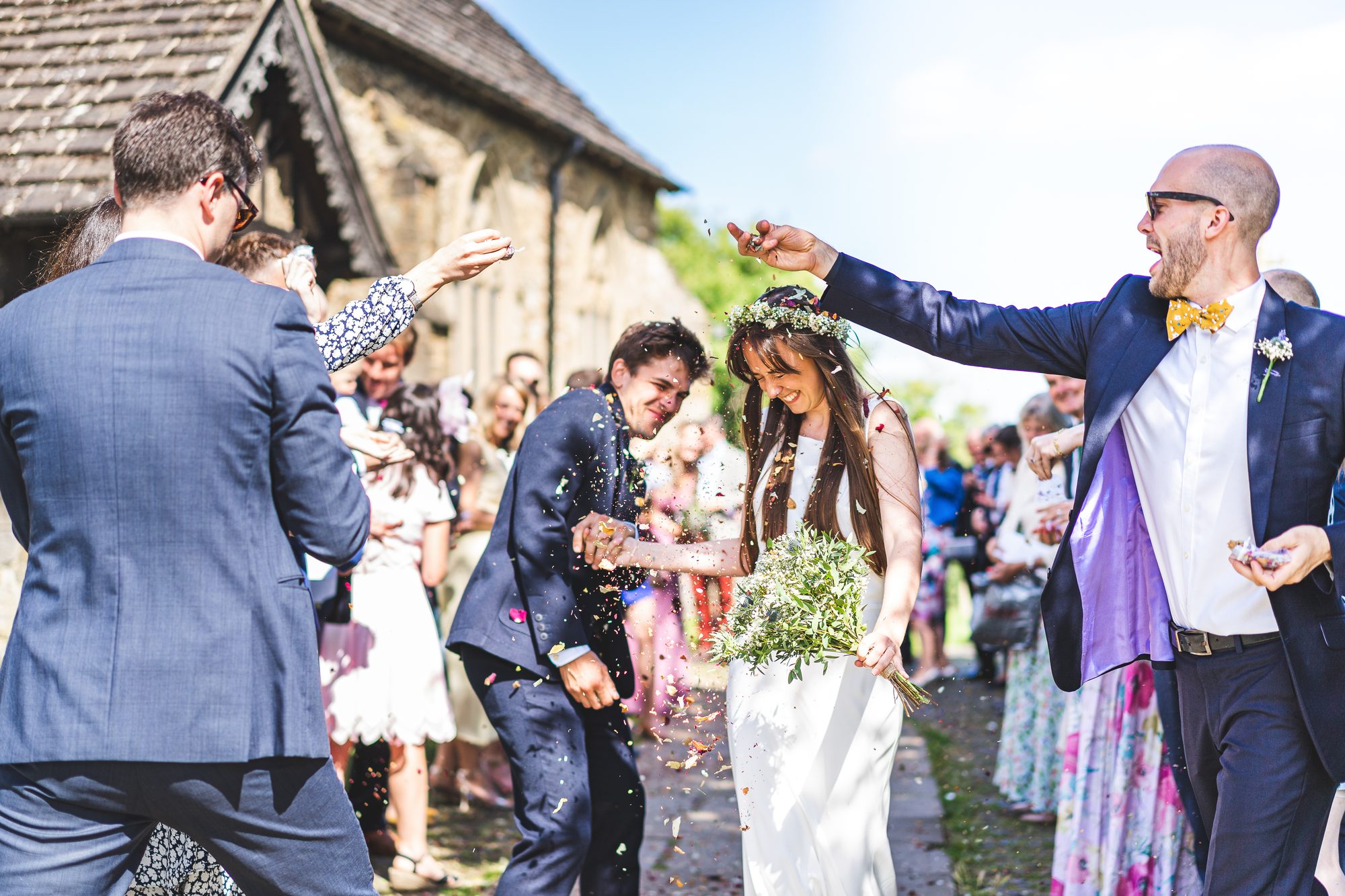 Confetti thrown over a couple leaving their wedding ceremony