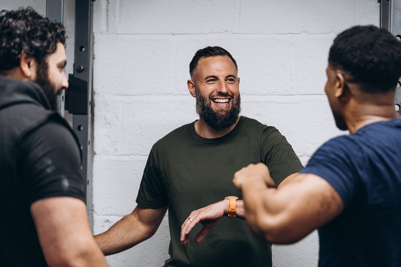 Two members laughing and bumping arms between rounds