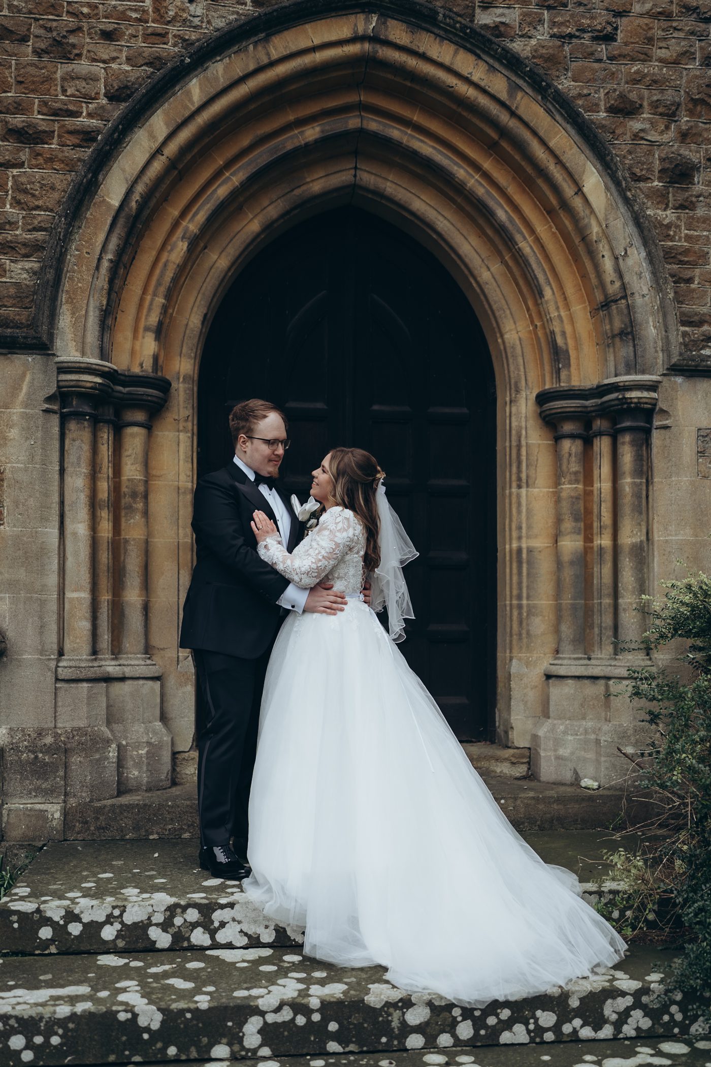Bride and groom at the doorway of St. John the Evangelist Church, Caterham Valley
