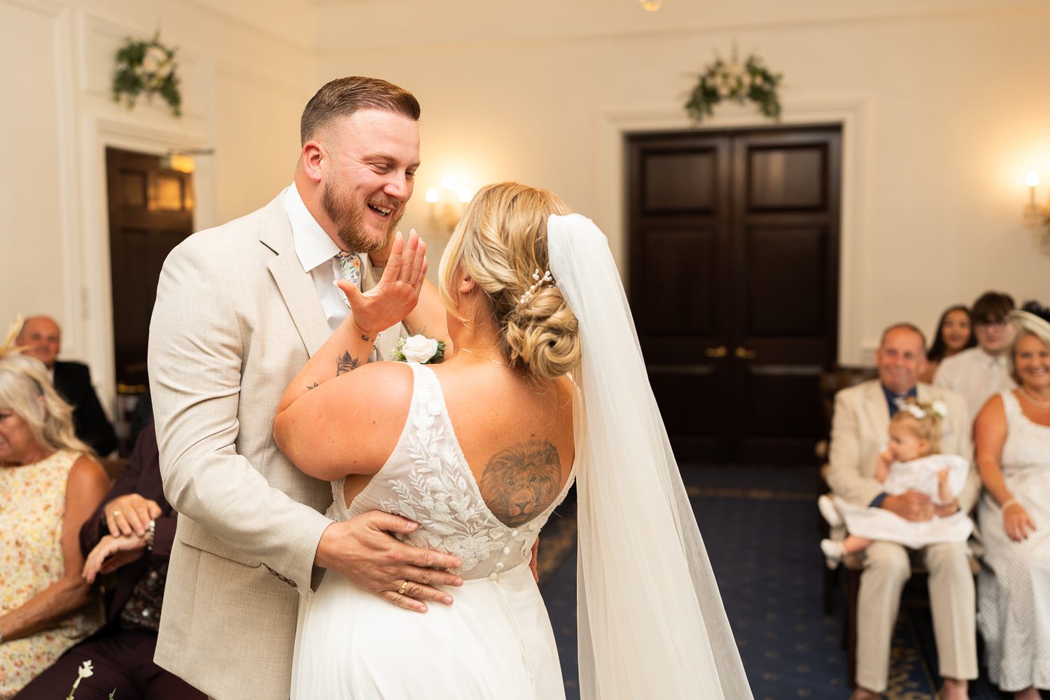 Guests applauding the first kiss at an intimate Surrey wedding
