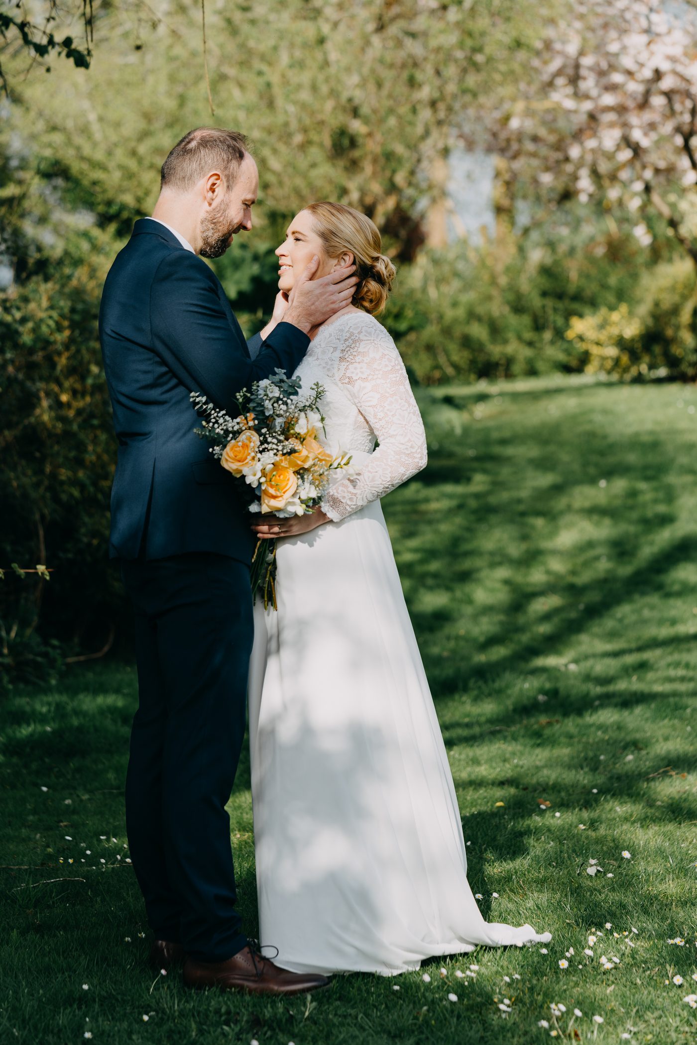Tender moment between newlyweds in a Surrey garden