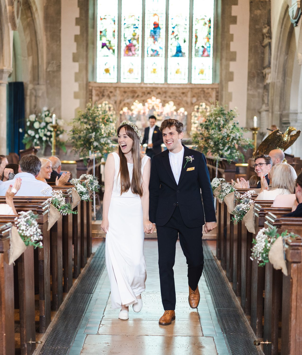 Bride and groom walking down the aisle at a Surrey church wedding